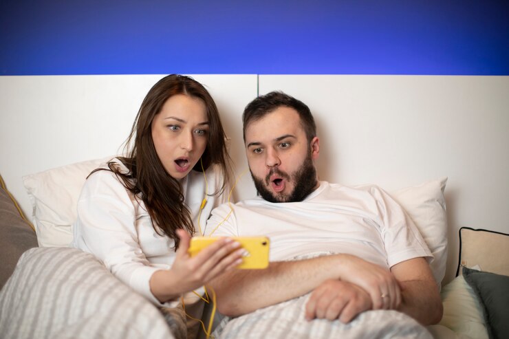 Shocked Scared Couple Watching Horror Movies Smartphone Lying Bed 213441 1768